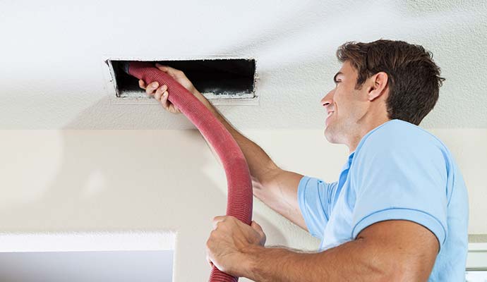 A person is removing smoke from duct system A person is removing smoke from duct system